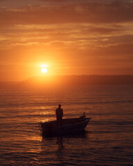 Naklejka na ściany i meble Boat fishing at sunrise