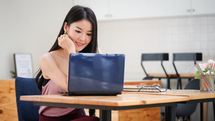 A young female administrative assistant making notes of working planning organizing information in her office.	