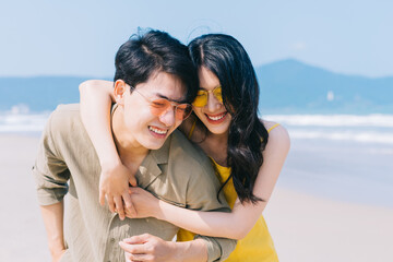 Young Asian couple enjoying summer vacation on the beach
