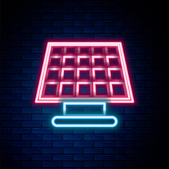 Glowing neon line Solar energy panel icon isolated on brick wall background. Colorful outline concept. Vector