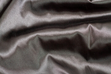 Gray elegant Silk fabric with a large fold and draped waves.