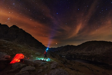 Starry nights in the High Tatras with a tourist in a tent on top	
