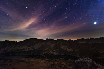 Starry nights in the High Tatras with a tourist in a tent on top	