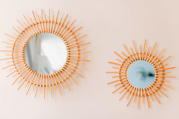 Two round mirrors as a decor hang on a round wall