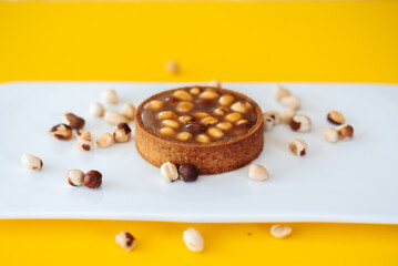 cake with nuts on yellow background