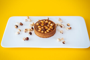 cake with nuts on yellow background