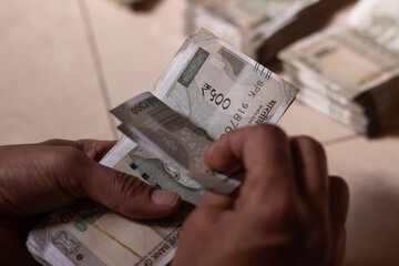 money in hand. person counting indian currency notes.
