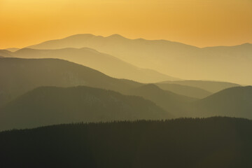 Beautiful sunrise in the Carpathian mountains with fog and dramatic sky	