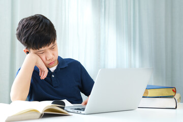 Remote learning new normal during Covid 19 pandemic. A smart teenager boy using laptop computer to join online classroom. Student, Homeschool, Virtual, Learning, Next normal, Home Based Learning.