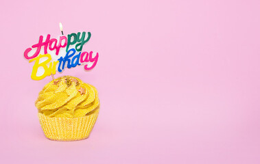 Cupcake with festive candle with the inscription happy birthday
