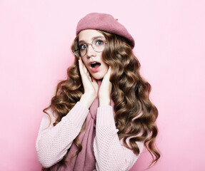 beautiful young female model with long wavy hair wearing pink beret , scarf and eyeglasses, close up