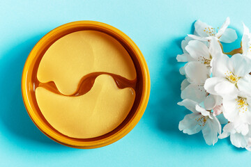 Transparent patches under in round jar on blue background top view.