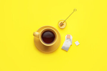 Composition with cup of tea on color background