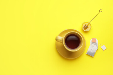 Composition with cup of tea on color background