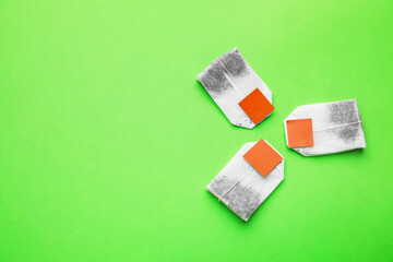 Tea bags on color background