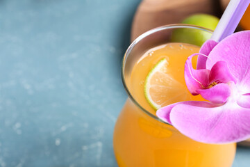 Glass of tasty mango margarita on color background