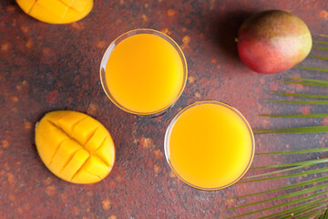 Glasses of tasty mango margarita on grunge background