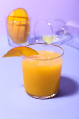 Glass of tasty mango margarita on color background