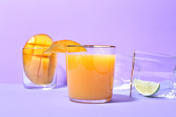 Glass of tasty mango margarita on color background