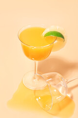 Glass of tasty mango margarita on color background