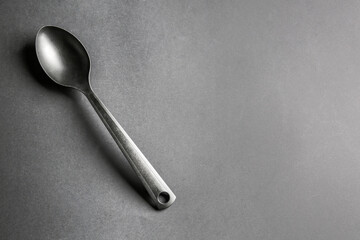 Stylish spoon on dark background