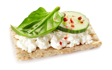 Crispbread with cottage cheese, cucumber and basil on white background