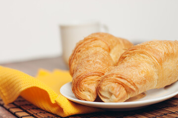 croissants white plates on the table kitchenware a cup 