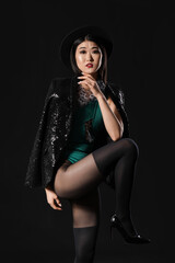 Obraz na płótnie Canvas Portrait of stylish Asian woman on dark background