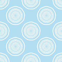 Seamless pattern of mandala flowers on a light blue background