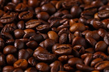Roasted brown coffee beans. Top view. Coffee background texture.