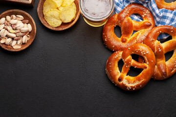 Lager beer, nuts, potato chips and fresh homemade pretzel