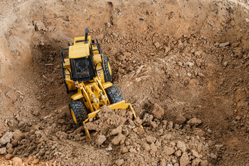 Wheel loader are digging the soil in the construction site ,Top view