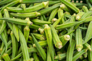 
Whole raw green okra vegetable food background