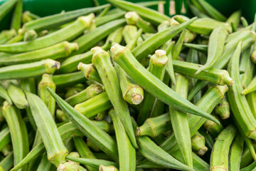 
Whole raw green okra vegetable food background
