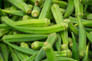 
Whole raw green okra vegetable food background