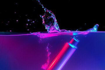 Skincare product bottle falling into water against black background in neon light