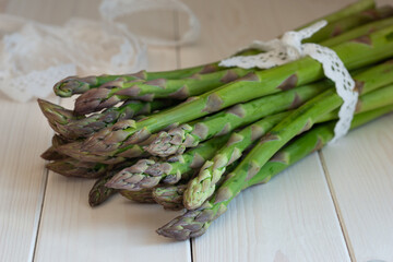 bunch of fresh green asparagus decorative lace ribbon
