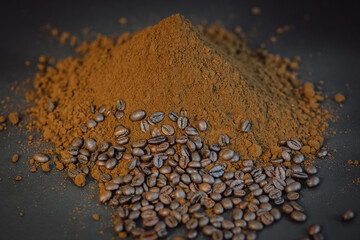 Finely ground coffee. Coffee powder and beans on black background.