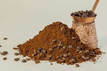 Coffee powder and roasted coffee beans on white background. Turk with coffee.