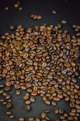 Roasted coffee beans on a black background. Coffee closeup.