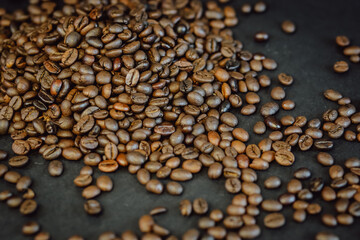 Coffee beans on a black background. Roasted Coffee closeup.