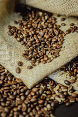 Roasted and green coffee beans on burlap closeup. Coffee beans background.
