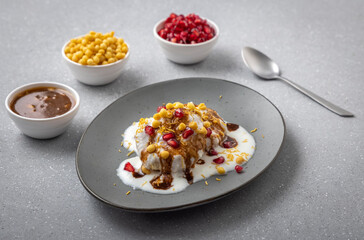 Indian tasty street food Dahi Bhalla or  Dahi Vada garnished with tamarind sauce and pomegranate...