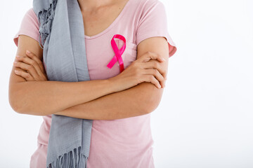 close up of woman in with pink breast cancer awareness ribbon isolated on pink blank copy space studio background,healthcare,medicine concept