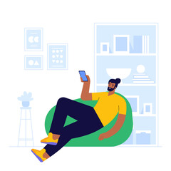 Man works at smartphone sitting in chair bag