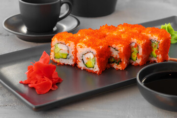 California sushi roll served on black ceramic plate