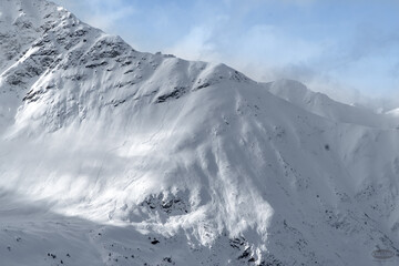 Fototapeta na wymiar Avalanche Slab on Mountain with Blue Sky