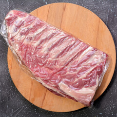 Raw pork ribs. Top the meat ingredient on a slate serving board. close-up.Selective Focus