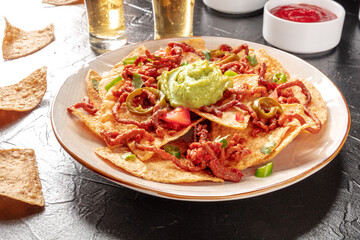 Nachos with beef and tequila in a bar