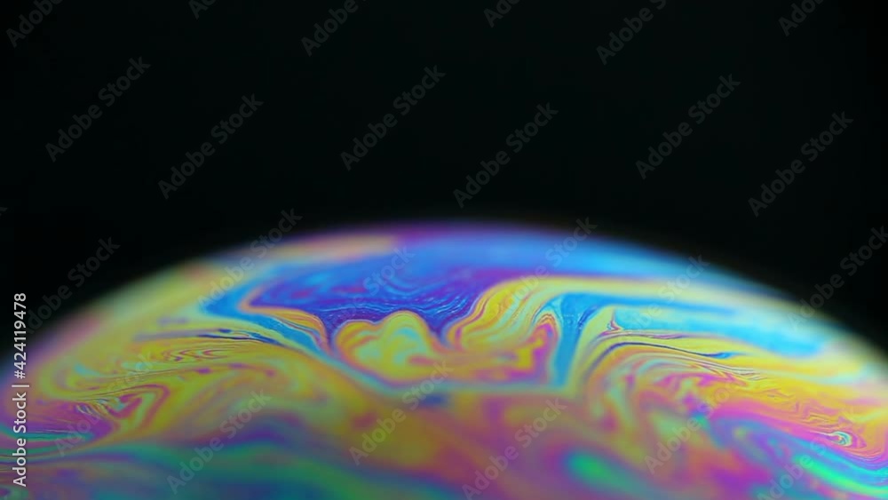 Sticker rotating colorful rainbow bubble on black background. abstract backdrop